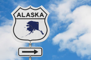Alaska Map And State Flag On A US Highway Road Sign