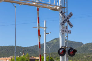A railroad crossing sign with the gate up