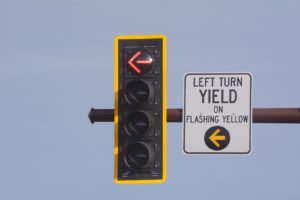 Left Turn On Yellow Yield Traffic Sign With Traffic Light With Red no turn light