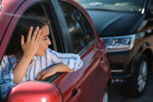 Young Woman Looking Distressed After Getting into a rear-ended accident