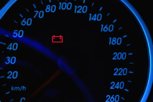 Close-up Of Red Warning Car Battery Light signal on a car's speedometer
